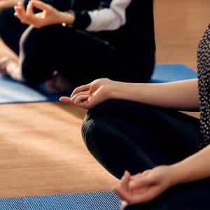 Corporate wellness session with people seated in meditation pose